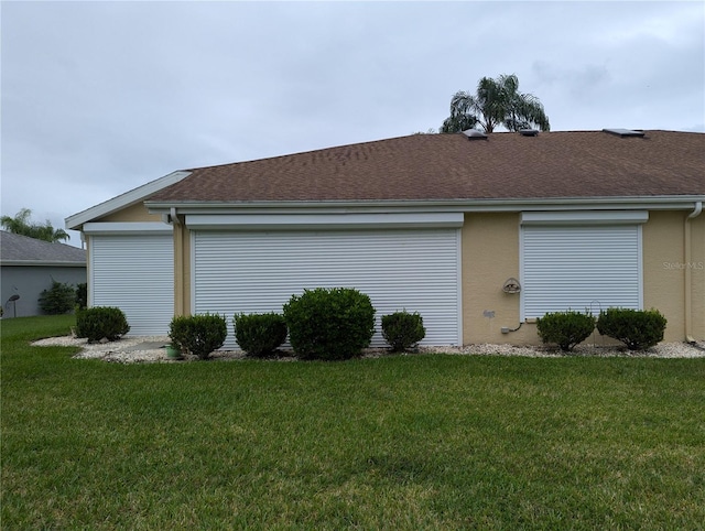 view of side of home with a lawn