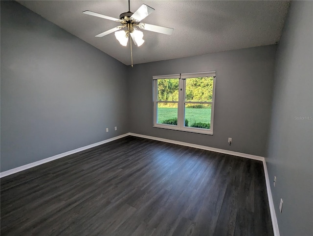 spare room with dark hardwood / wood-style floors, ceiling fan, a textured ceiling, and vaulted ceiling