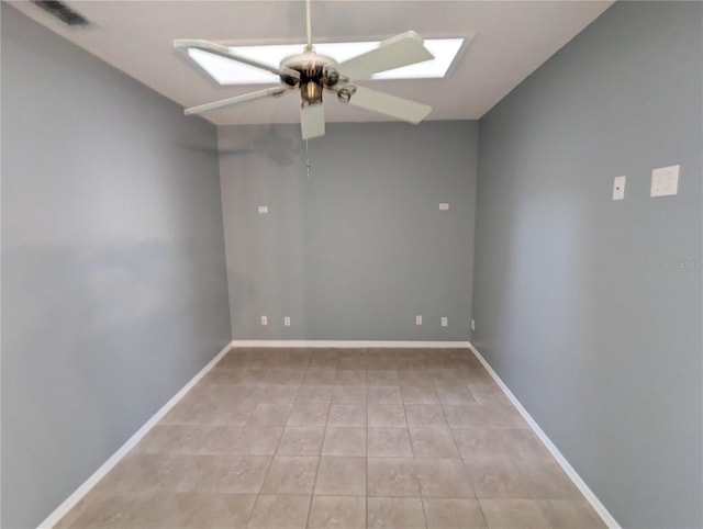 unfurnished room with ceiling fan and light tile patterned flooring