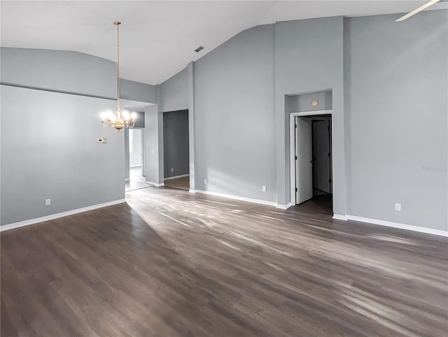 spare room with high vaulted ceiling, dark hardwood / wood-style floors, and an inviting chandelier