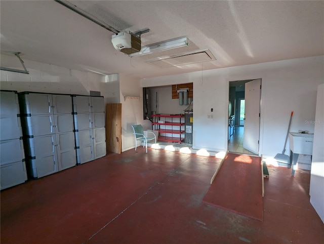 garage featuring electric water heater and a garage door opener