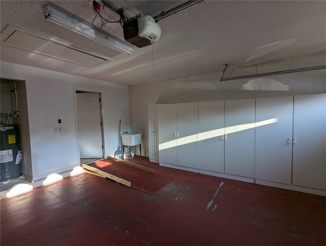 garage featuring sink, a garage door opener, and water heater