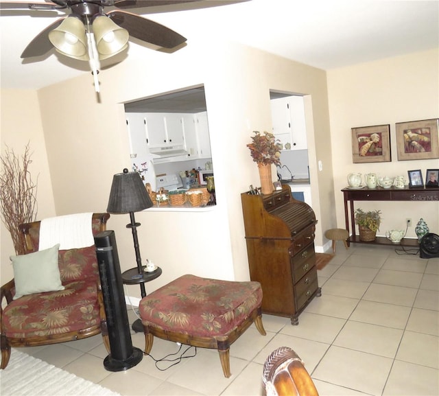 living area with ceiling fan and light tile patterned flooring