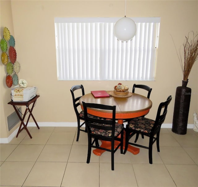 dining space featuring light tile patterned floors