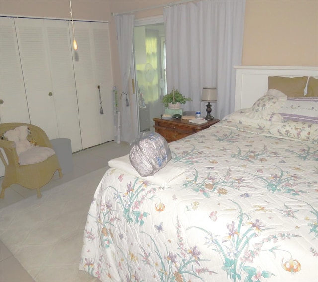 tiled bedroom featuring a closet