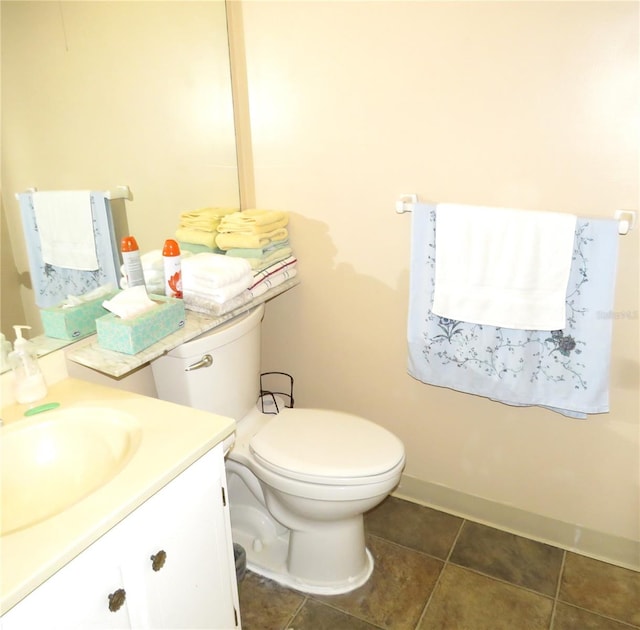 bathroom featuring tile patterned floors, vanity, and toilet