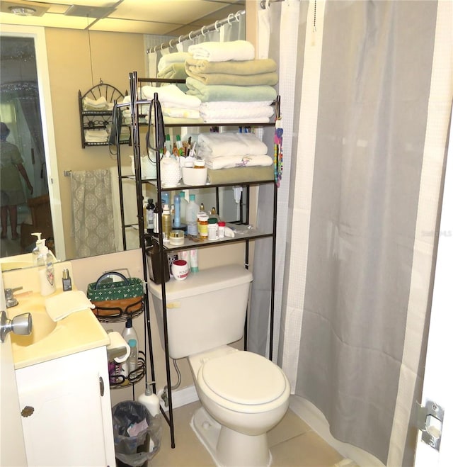 bathroom featuring tile patterned flooring, vanity, and toilet