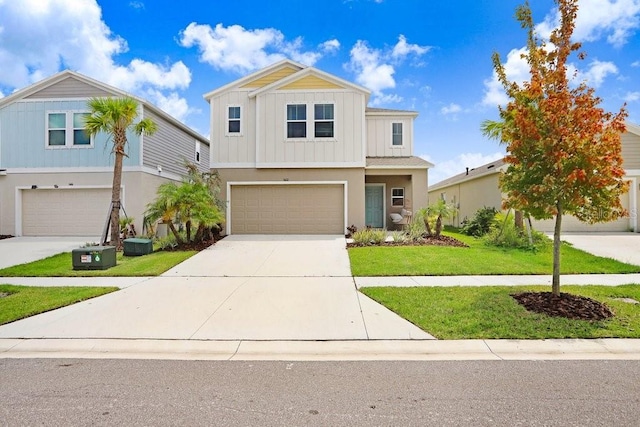 view of front of house with a front yard, central AC unit, and a garage