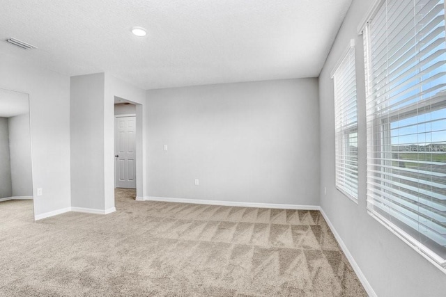 empty room with light colored carpet