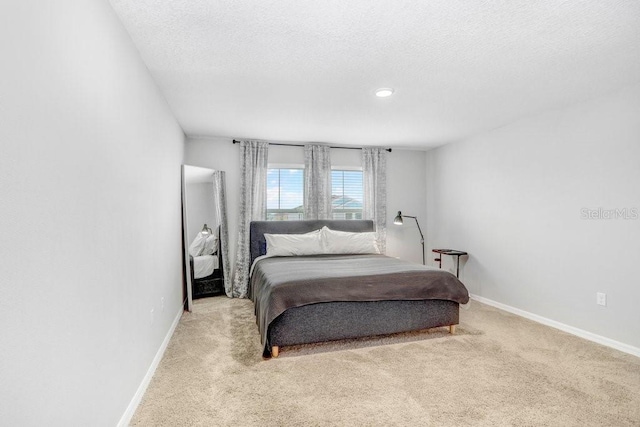 carpeted bedroom with a textured ceiling