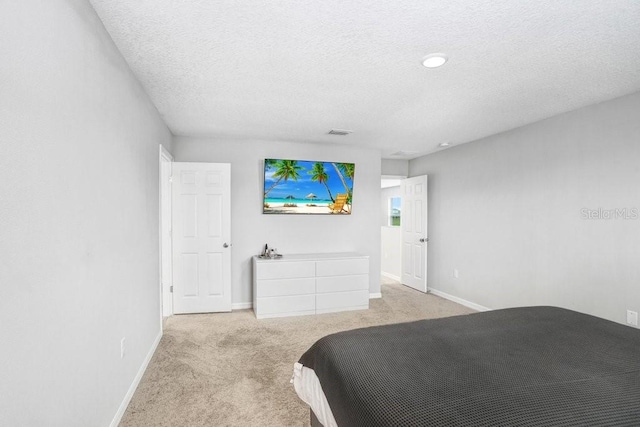 carpeted bedroom with a textured ceiling