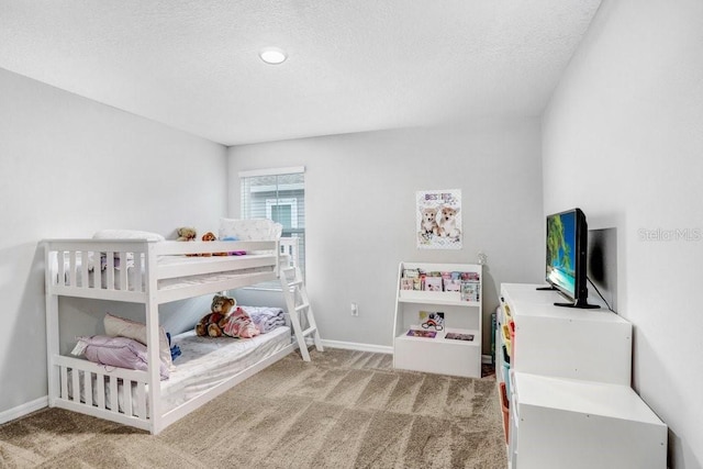 bedroom with a textured ceiling and carpet flooring