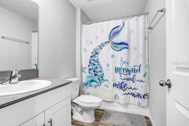 full bathroom featuring hardwood / wood-style floors, a textured ceiling, toilet, shower / bath combo, and vanity