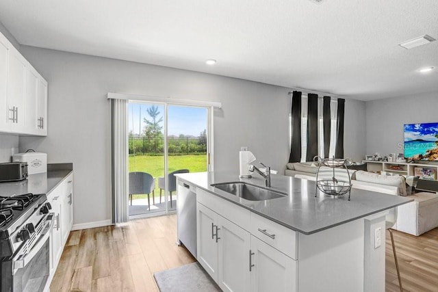 kitchen with white cabinetry, light hardwood / wood-style flooring, stainless steel appliances, and sink