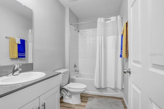 full bathroom with vanity, hardwood / wood-style floors, shower / bath combo, and toilet