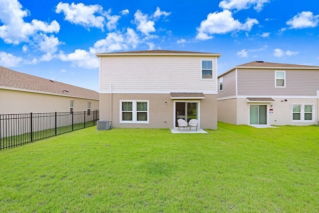 back of house featuring a patio area, a lawn, and central AC unit