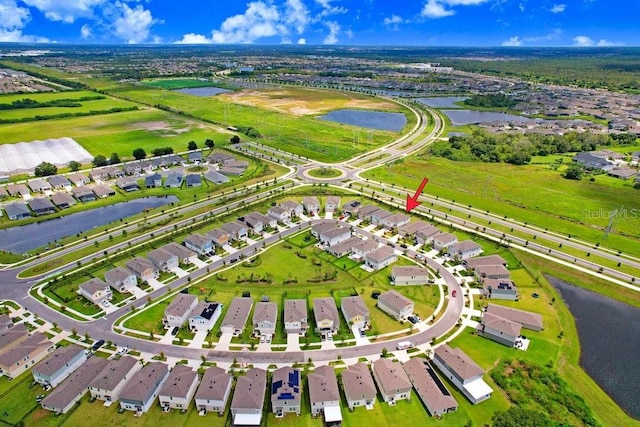 birds eye view of property with a water view