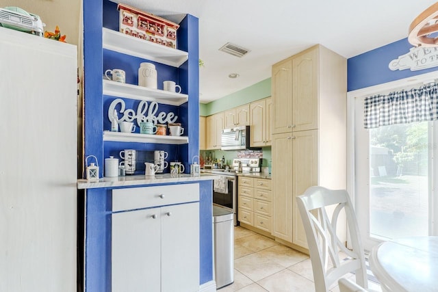 kitchen featuring light tile patterned floors, visible vents, light countertops, appliances with stainless steel finishes, and open shelves