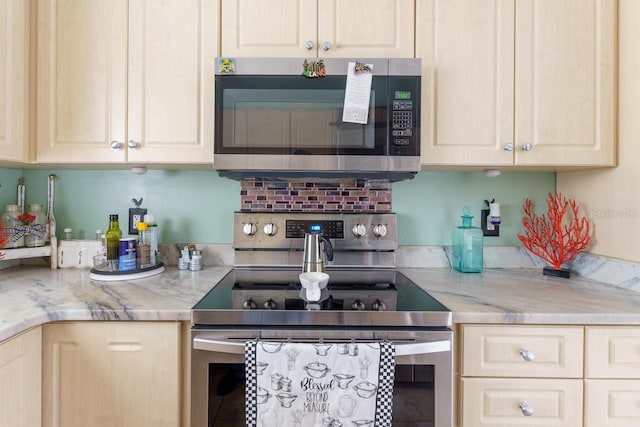 kitchen with appliances with stainless steel finishes and light stone countertops