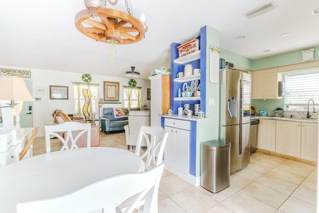 kitchen with a healthy amount of sunlight, appliances with stainless steel finishes, light countertops, and a sink