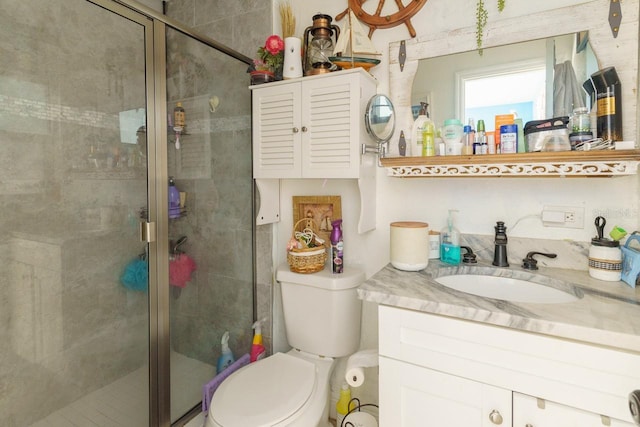 full bath featuring toilet, a shower stall, and vanity