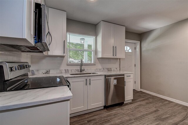 kitchen with sink, white cabinetry, dark wood-type flooring, and stainless steel appliances