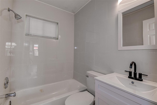 full bathroom featuring tasteful backsplash, toilet, tile walls, tiled shower / bath, and vanity