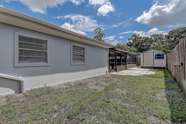 view of yard with a patio and a storage unit