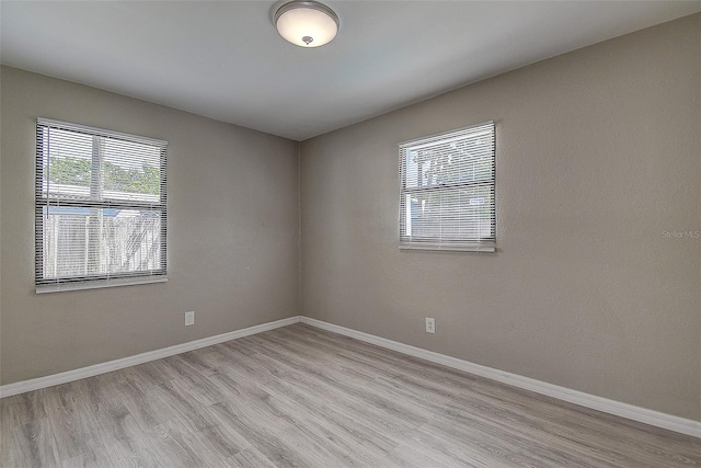 spare room featuring light hardwood / wood-style flooring