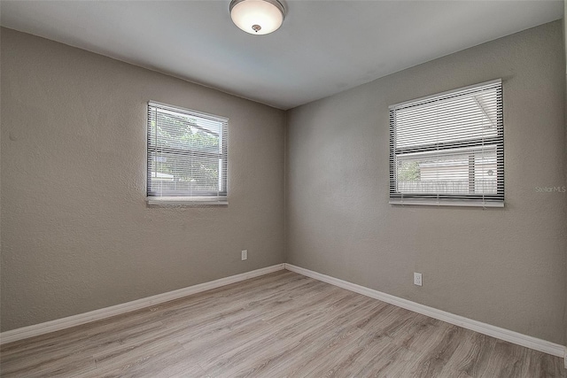 unfurnished room with light hardwood / wood-style flooring