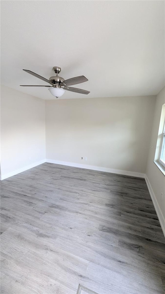 unfurnished room featuring ceiling fan and hardwood / wood-style flooring