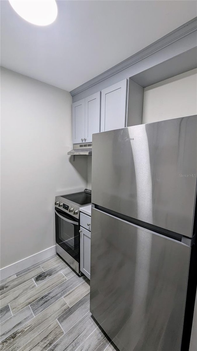 kitchen featuring light wood-type flooring and appliances with stainless steel finishes