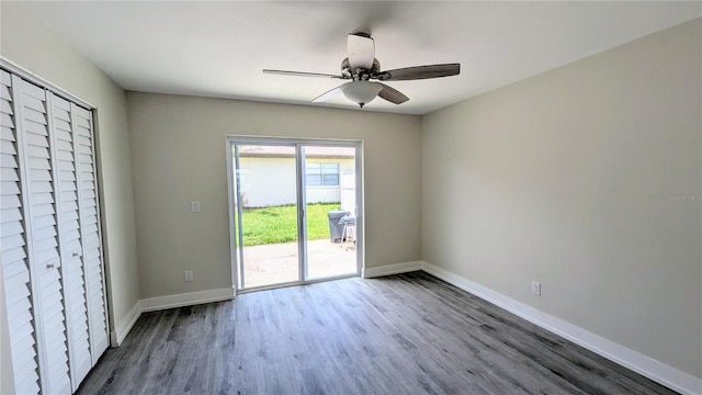 unfurnished bedroom featuring ceiling fan, access to outside, and wood-type flooring