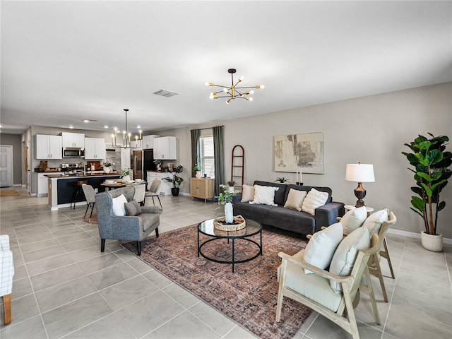 tiled living room with an inviting chandelier