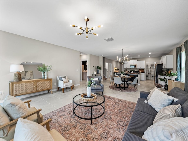 living room with light tile patterned flooring and an inviting chandelier