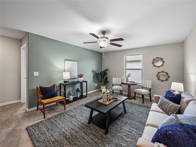 carpeted living room with ceiling fan