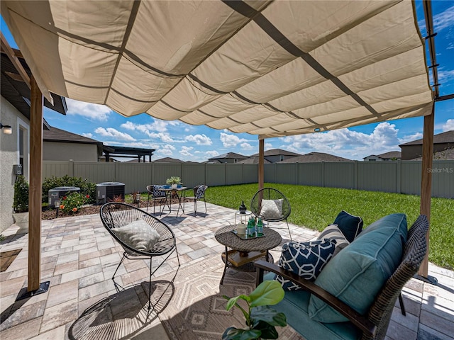 view of patio with a fenced backyard, outdoor dining area, and central AC