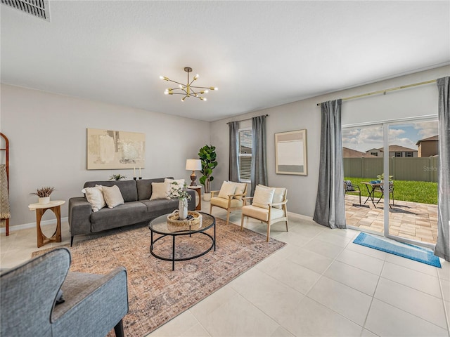 living room featuring a notable chandelier and light tile patterned flooring