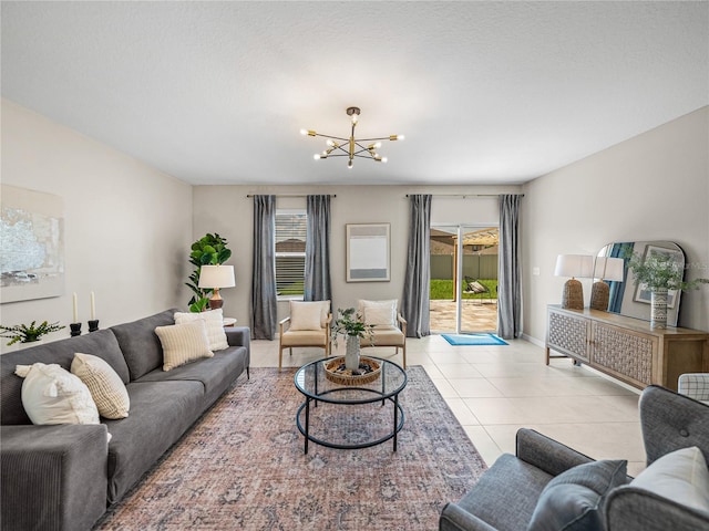 living room with a chandelier and light tile patterned flooring