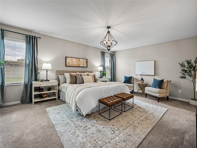 bedroom with a chandelier and carpet floors