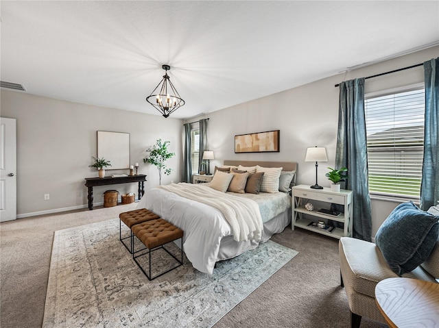 bedroom with a chandelier and carpet floors