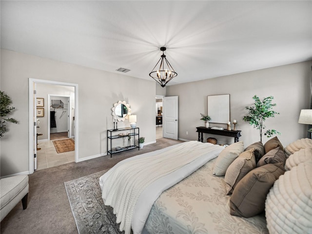 bedroom featuring carpet and a chandelier