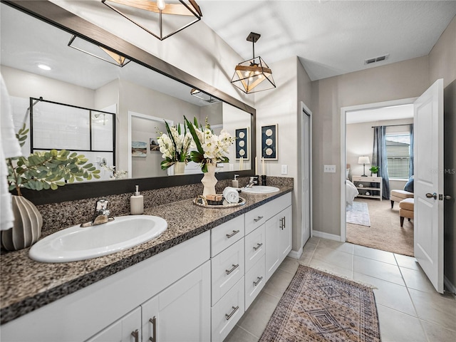 bathroom with tile patterned flooring, vanity, and a shower with shower door