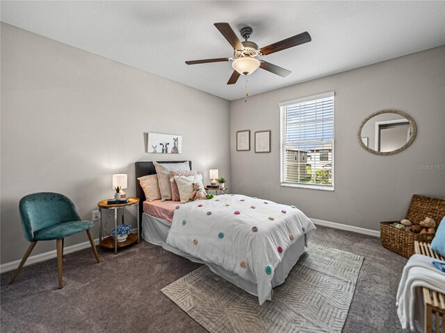 bedroom with ceiling fan and dark colored carpet