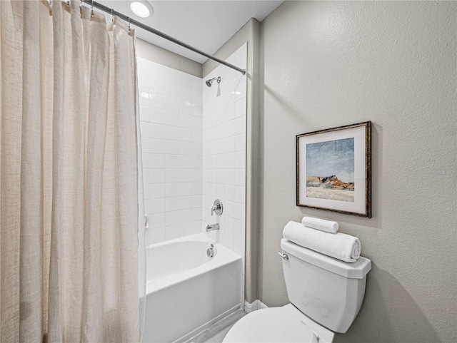 bathroom featuring shower / bath combo and toilet