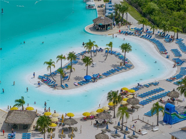 aerial view with a water view and a view of the beach