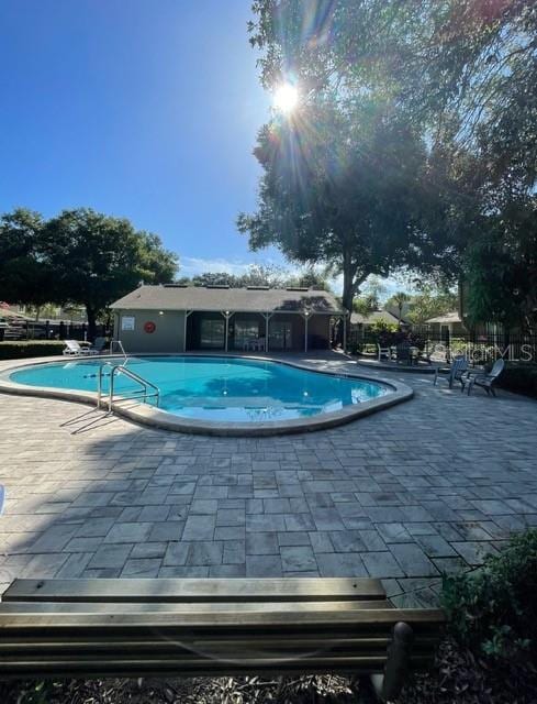 view of swimming pool with a patio area