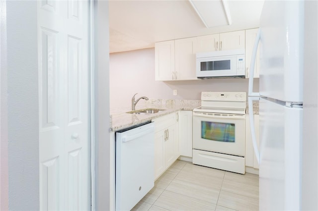 kitchen featuring sink, light tile patterned floors, white appliances, and white cabinets