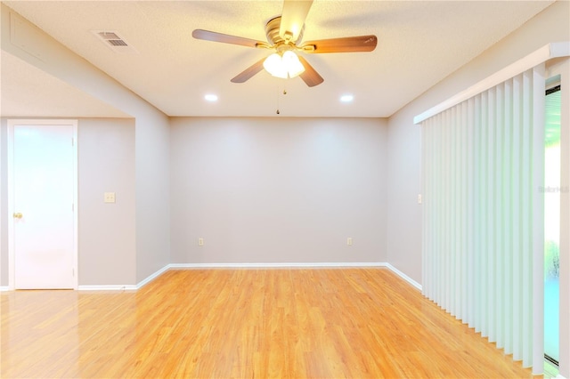 spare room featuring ceiling fan and hardwood / wood-style flooring