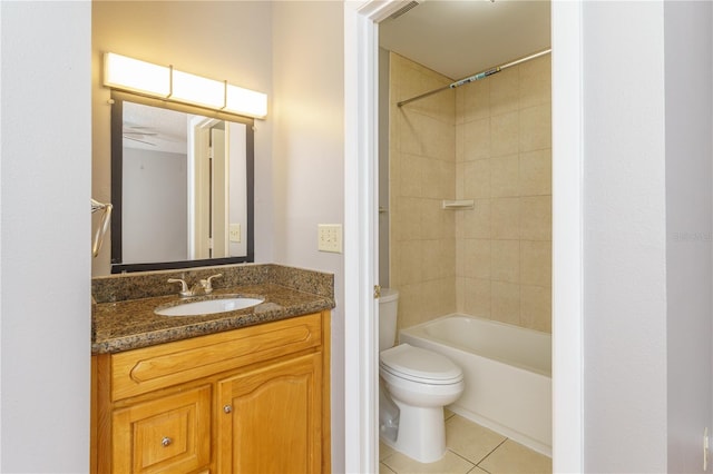 full bathroom featuring tiled shower / bath, vanity, toilet, and tile patterned floors